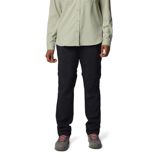 Person wearing a light green shirt and black pants on a white background