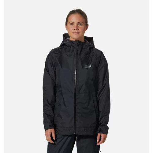 A woman wearing a black Mountain Hardwear women's threshold jacket with a hood, featuring a front zipper and hand pockets.