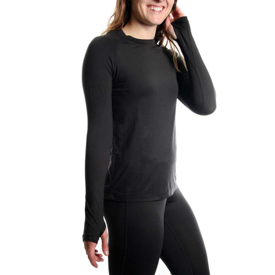 Person wearing a black long-sleeve athletic shirt and leggings on a white background