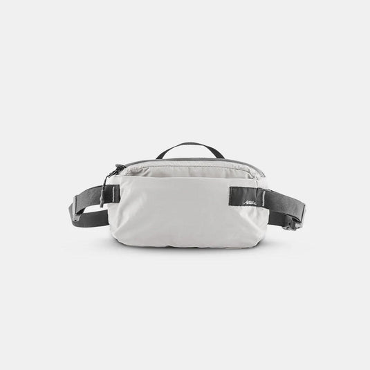 White waist bag with black straps on a light gray background