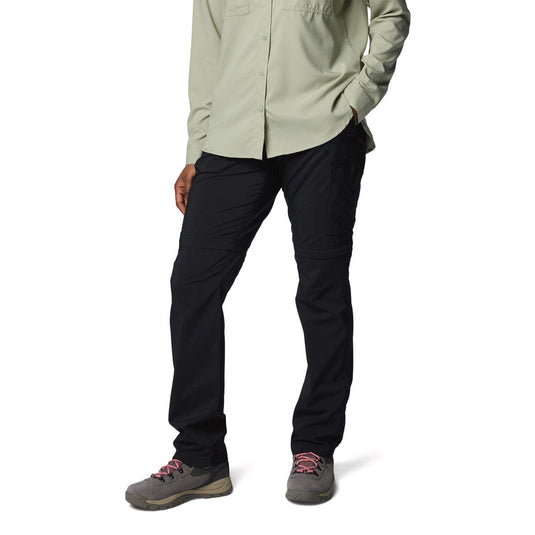 Person wearing black pants and a light-colored shirt on a white background