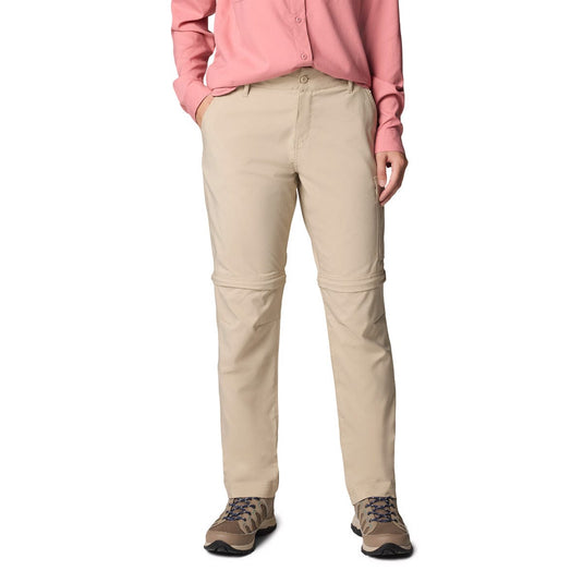 Person wearing beige pants and a pink shirt on a white background